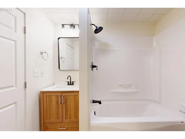 a front view of house with yard and trees in the background