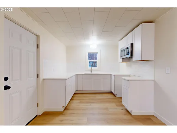 a kitchen with a sink and cabinets