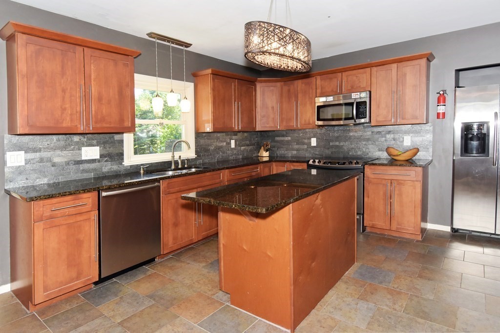 64 Kinnicutt Road Worcester, MA 01602 - Photo 11 of 38 a kitchen with stainless steel appliances granite countertop a sink counter space cabinets and a large window