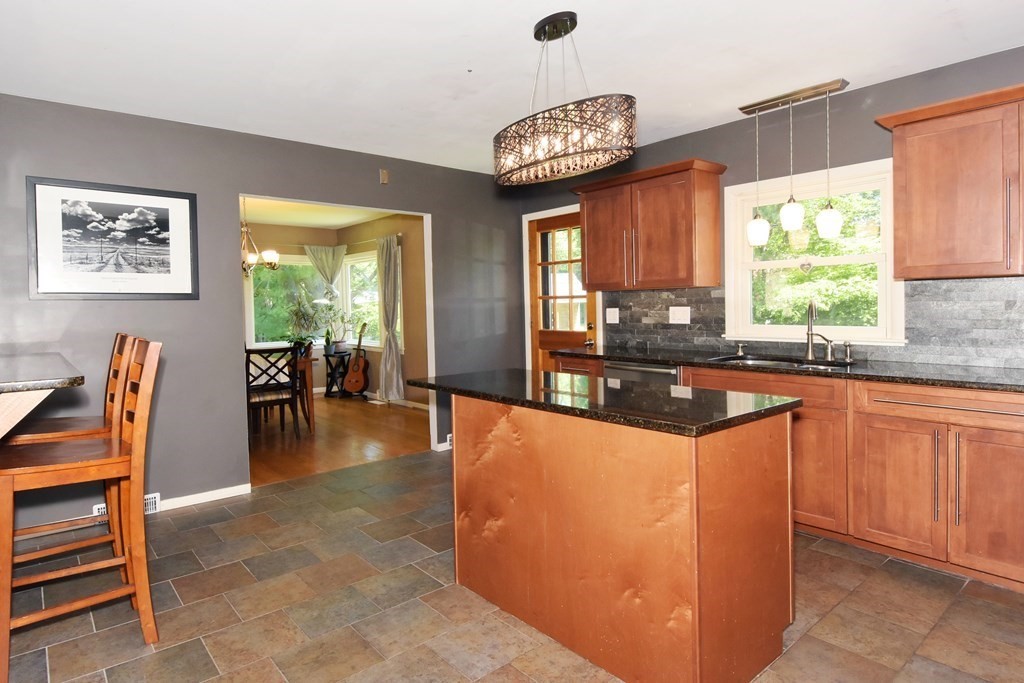 64 Kinnicutt Road Worcester, MA 01602 - Photo 12 of 38 a large kitchen with granite countertop a stove a sink a table and chairs