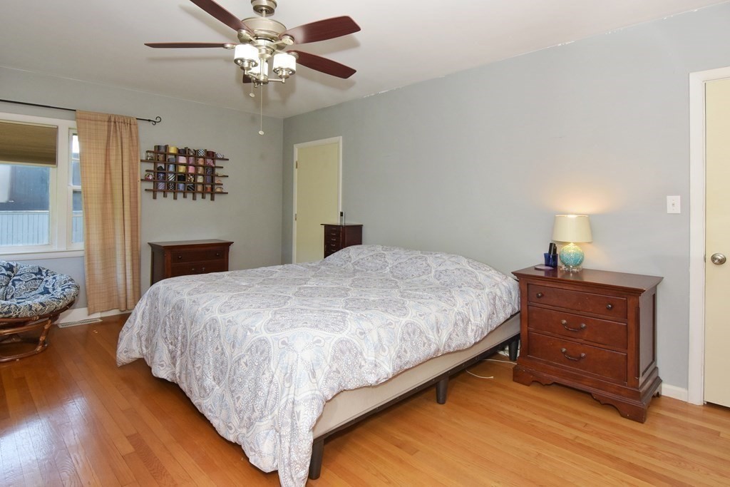 64 Kinnicutt Road Worcester, MA 01602 - Photo 13 of 38 a bedroom with a bed and wooden floor
