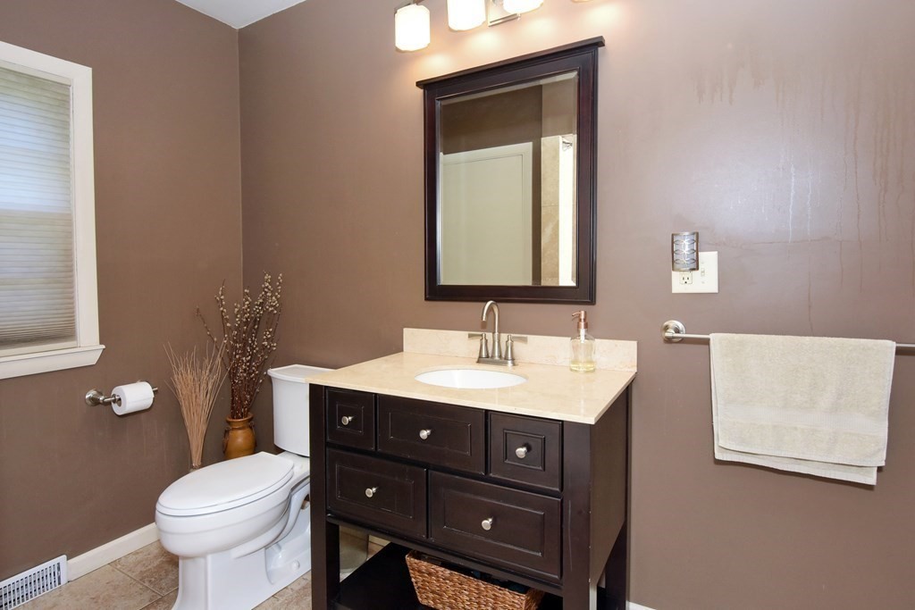 64 Kinnicutt Road Worcester, MA 01602 - Photo 24 of 38 a bathroom with a toilet a sink and mirror
