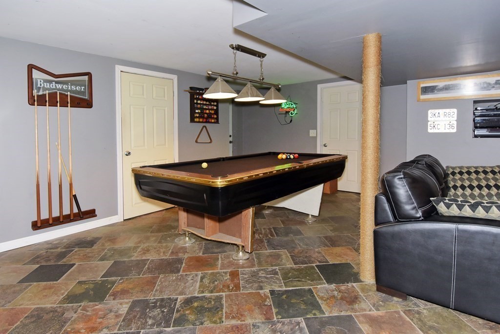 64 Kinnicutt Road Worcester, MA 01602 - Photo 28 of 38 a living room with a couch and a chandelier