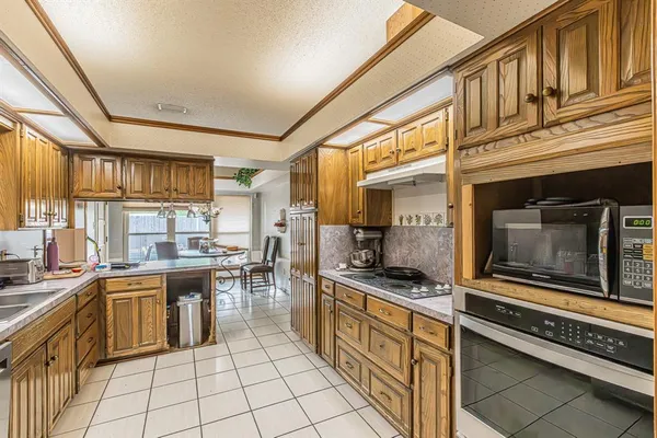 a kitchen with stainless steel appliances a stove sink and cabinets