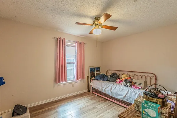 a bedroom with a bed and wooden floor