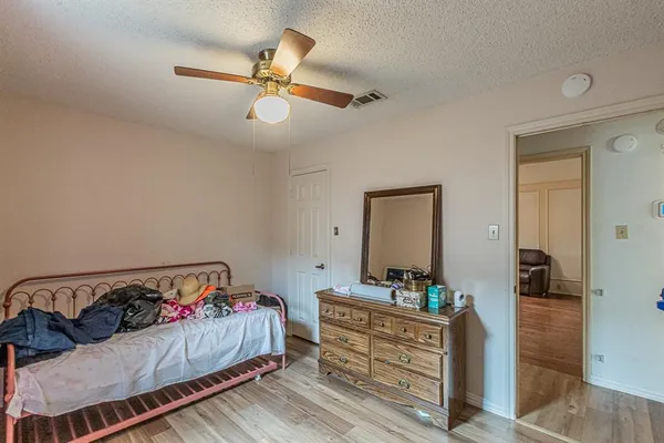 a bedroom with a bed and a mirror