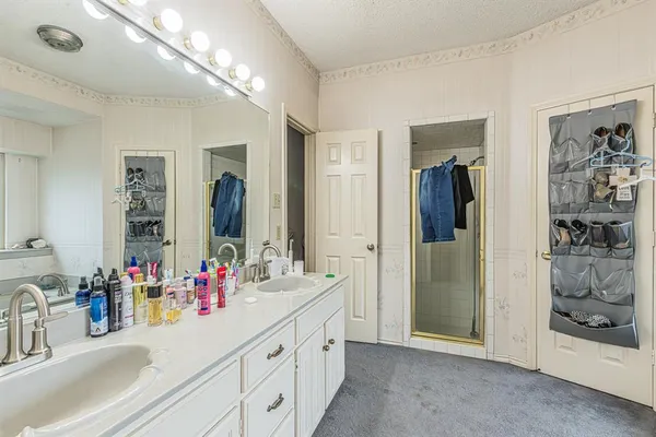 a bathroom with a double vanity sink and a mirror