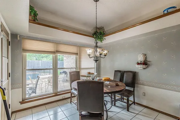 a dining room with furniture a chandelier and window