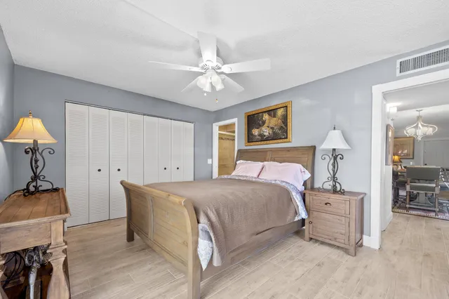 a bedroom with a bed and a chandelier