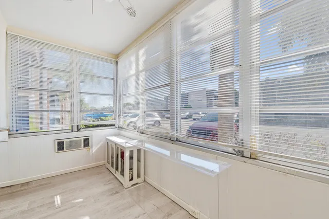 a large white kitchen with a sink and cabinets