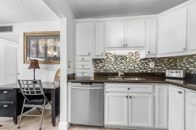 a kitchen with stainless steel appliances granite countertop a sink and cabinets