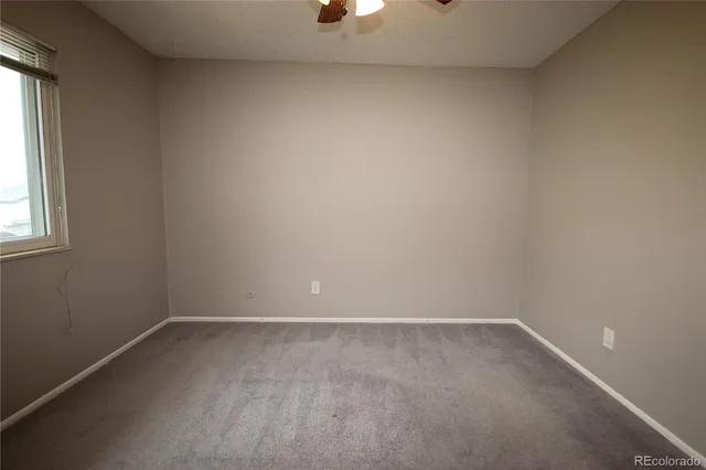 a view of a room with wooden floor and windows