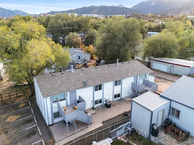 an aerial view of a house with a yard swimming pool and mountain view