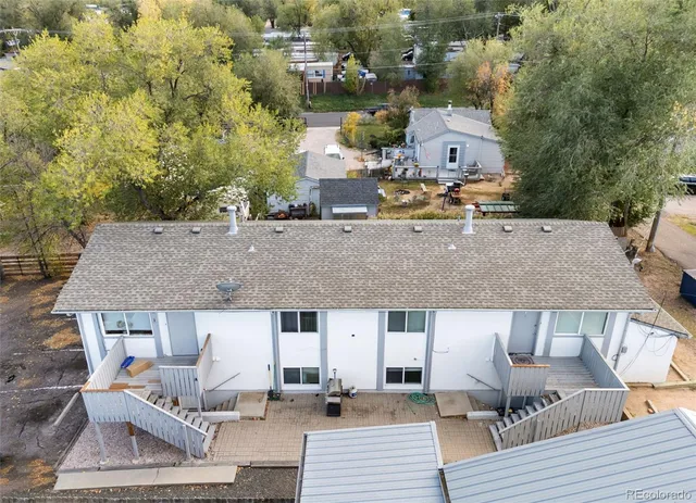an aerial view of a house with swimming pool and patio