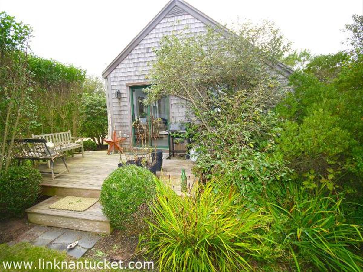 22 Miacomet Road Nantucket, MA 02554 - Photo 6 of 19 a view of a house with backyard porch and sitting area