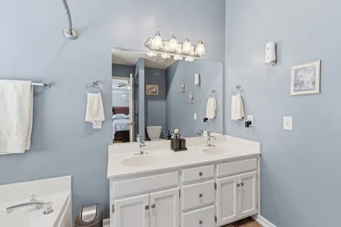 a bathroom with a double vanity sink and a mirror