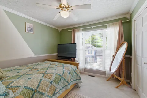 a bedroom with a bed and a flat tv screen