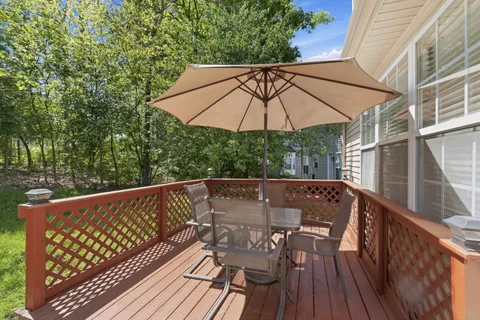 a view of balcony with wooden floor and outdoor seating
