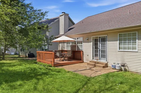 a front view of a house with a yard and outdoor seating
