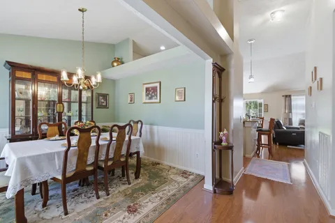 a view of a dining room with furniture and wooden floor
