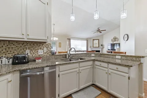 a kitchen with sink a stove and cabinets
