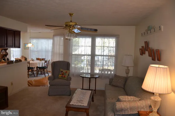 a living room with furniture and a lamp