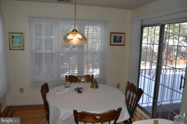 a view of a dining room with furniture wooden floor and chandelier