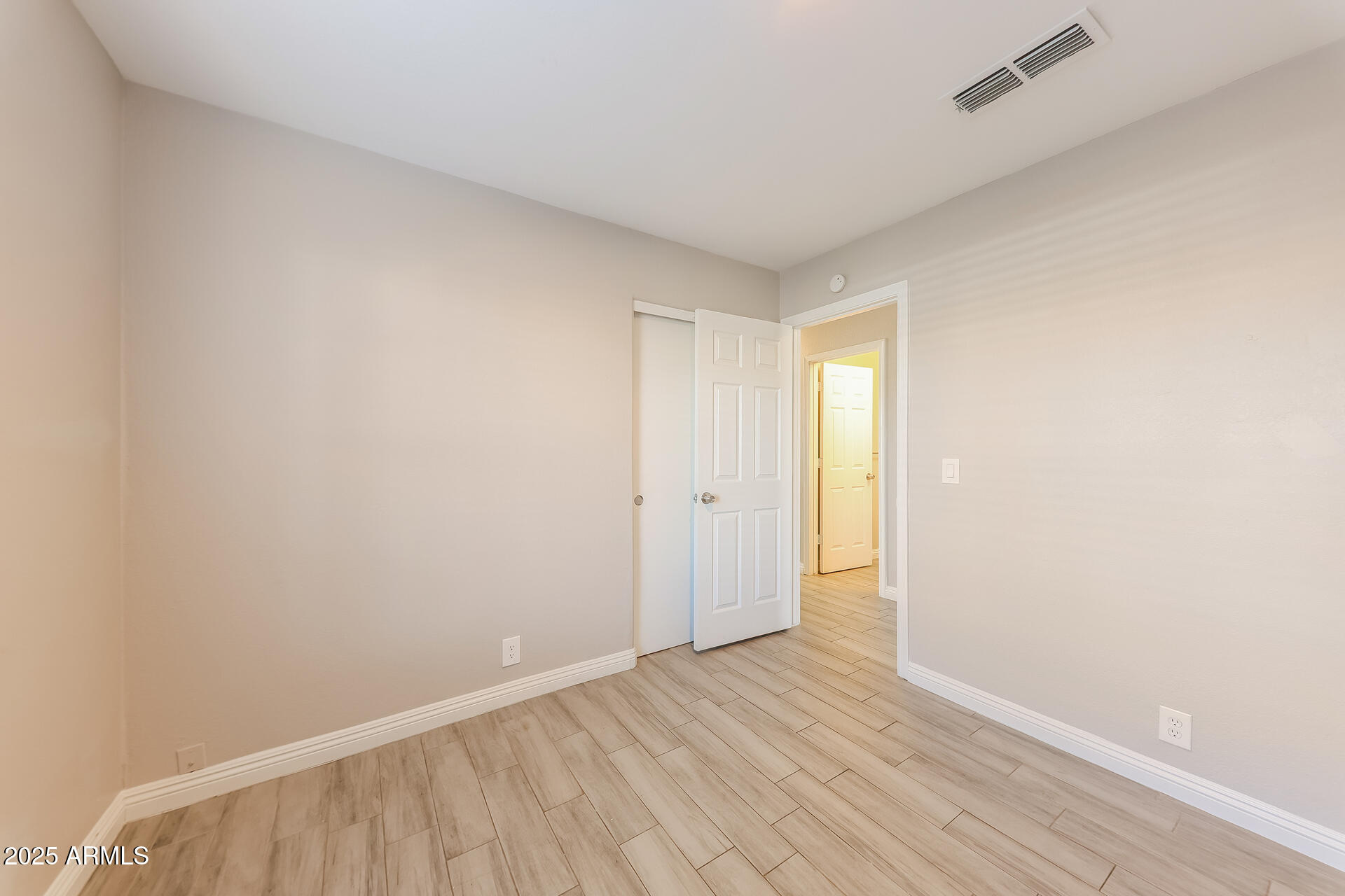 8833 West Monte Vista Road Phoenix, AZ 85037 - Photo 17 of 21 a view of an empty room and wooden floor