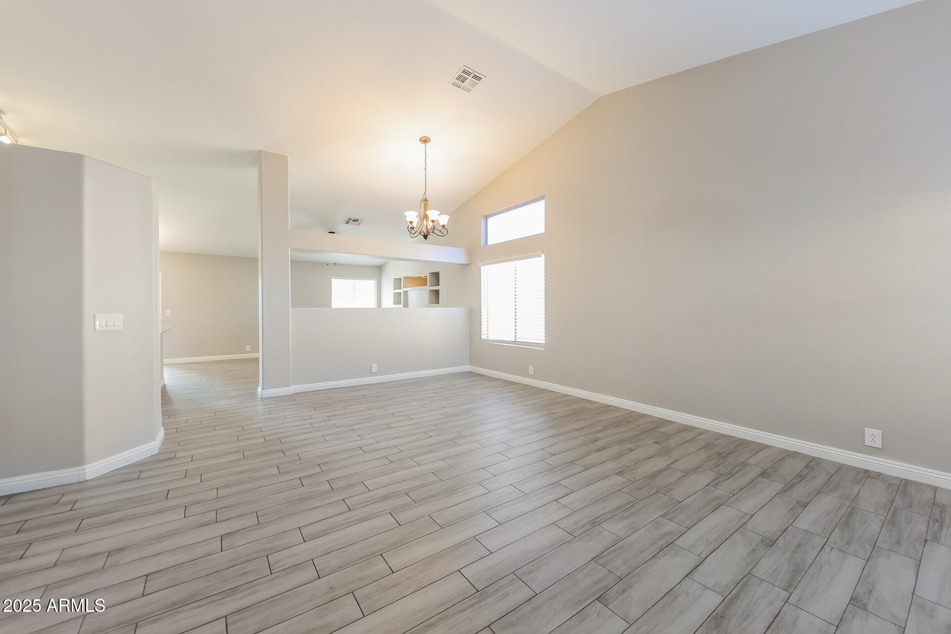 8833 West Monte Vista Road Phoenix, AZ 85037 - Photo 2 of 21 a view of empty room with wooden floor and window