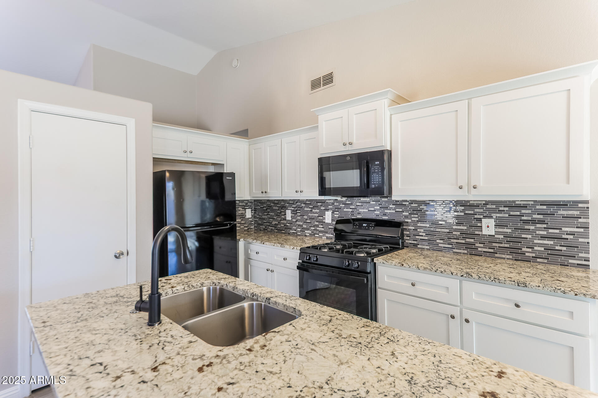 8833 West Monte Vista Road Phoenix, AZ 85037 - Photo 5 of 21 a kitchen with a sink stove and refrigerator