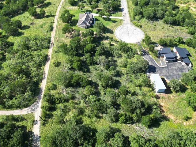 an aerial view of a house with a yard and outdoor seating