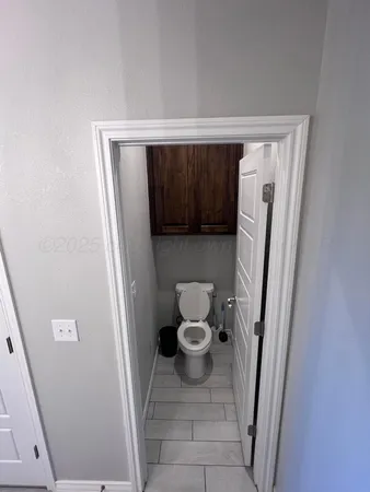 a bathroom with a granite countertop sink a mirror and shower