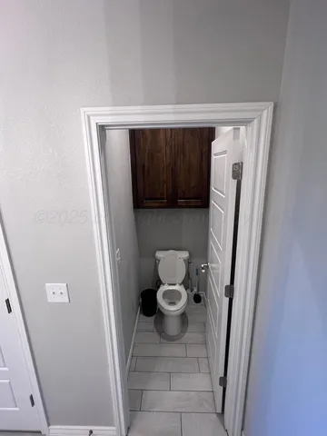 a bathroom with a granite countertop sink a mirror and shower