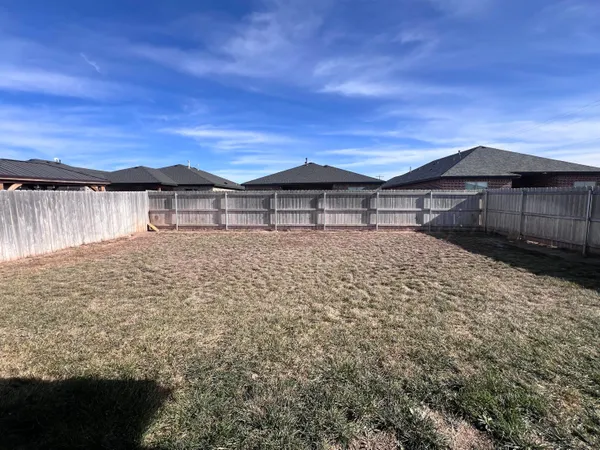 a large house with a big yard and large tree