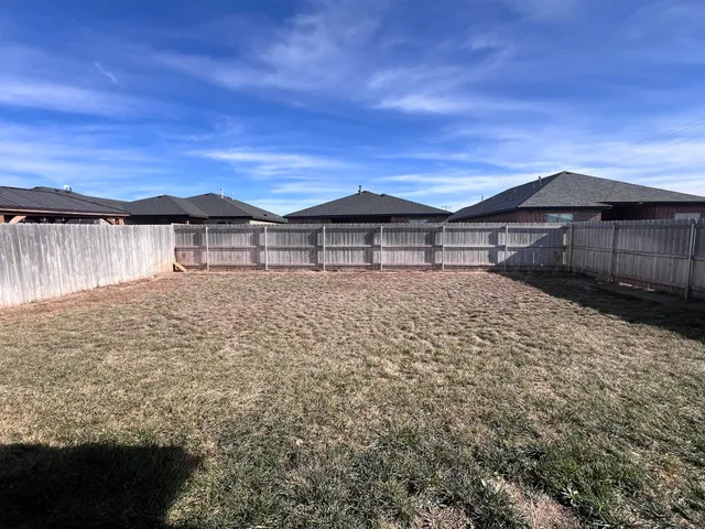 a large house with a big yard and large tree