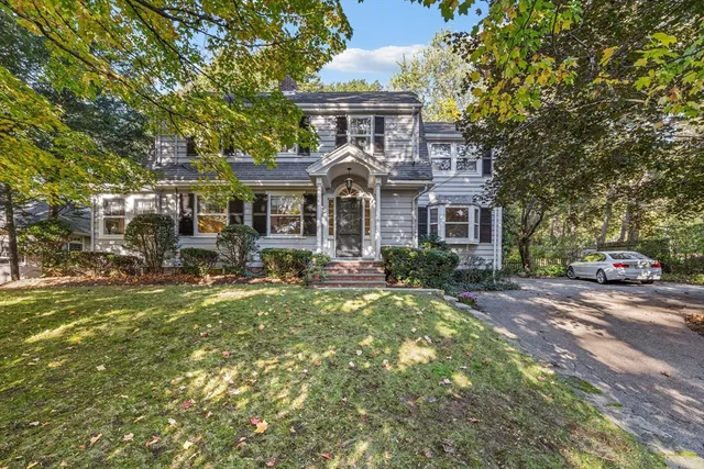 a front view of a house with a garden