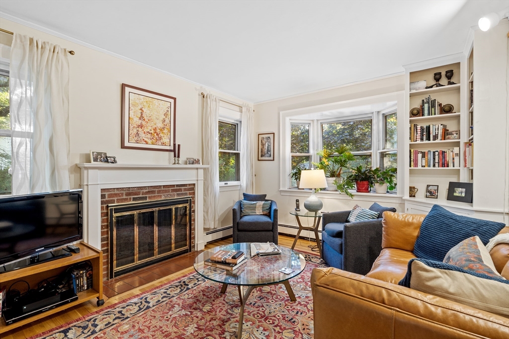 30 Burlington Street Lexington, MA 02420 - Photo 11 of 34 a living room with furniture a flat screen tv and a fireplace