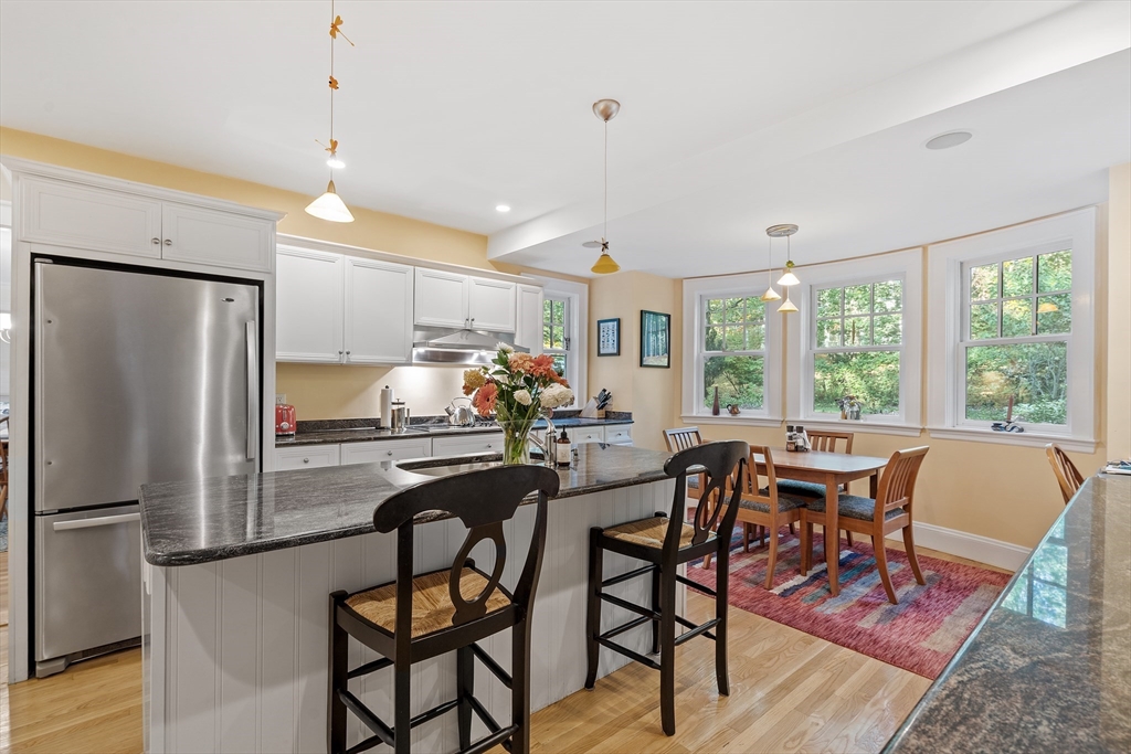 30 Burlington Street Lexington, MA 02420 - Photo 13 of 34 a dining room with furniture a chandelier and wooden floor