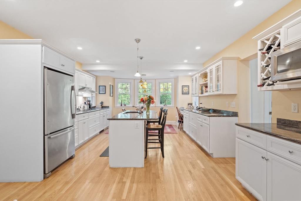 30 Burlington Street Lexington, MA 02420 - Photo 14 of 34 a kitchen with white cabinets and stainless steel appliances