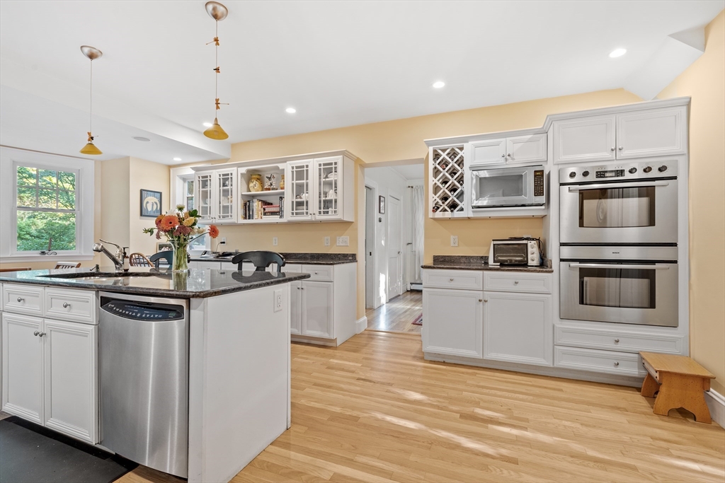 30 Burlington Street Lexington, MA 02420 - Photo 16 of 34 a kitchen with stainless steel appliances granite countertop a stove and cabinets