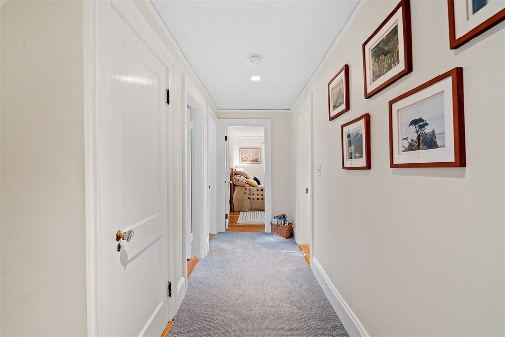 30 Burlington Street Lexington, MA 02420 - Photo 19 of 34 a view of a hallway with paintings on the wall