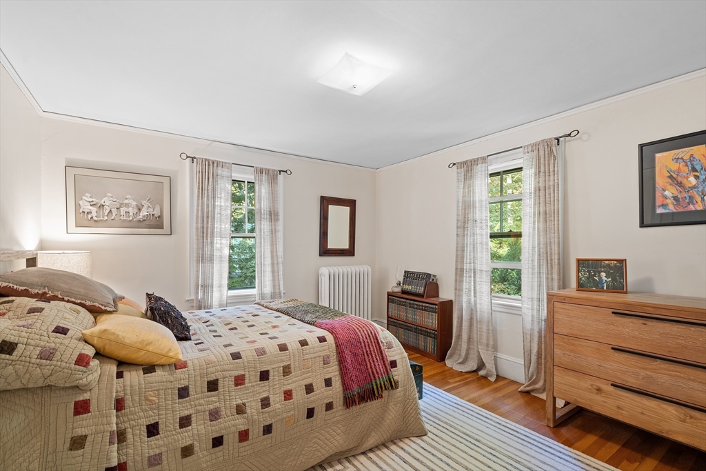 30 Burlington Street Lexington, MA 02420 - Photo 24 of 34 a bedroom with a bed and wooden floor