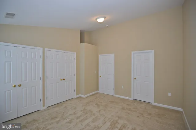 a view of an empty room and closet area