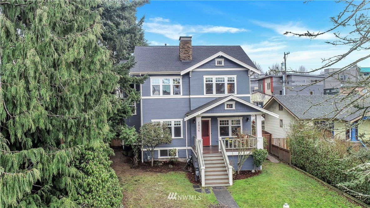 6016 44th Avenue Southwest Seattle, WA 98136 - Photo 1 of 35 a front view of a house with a yard