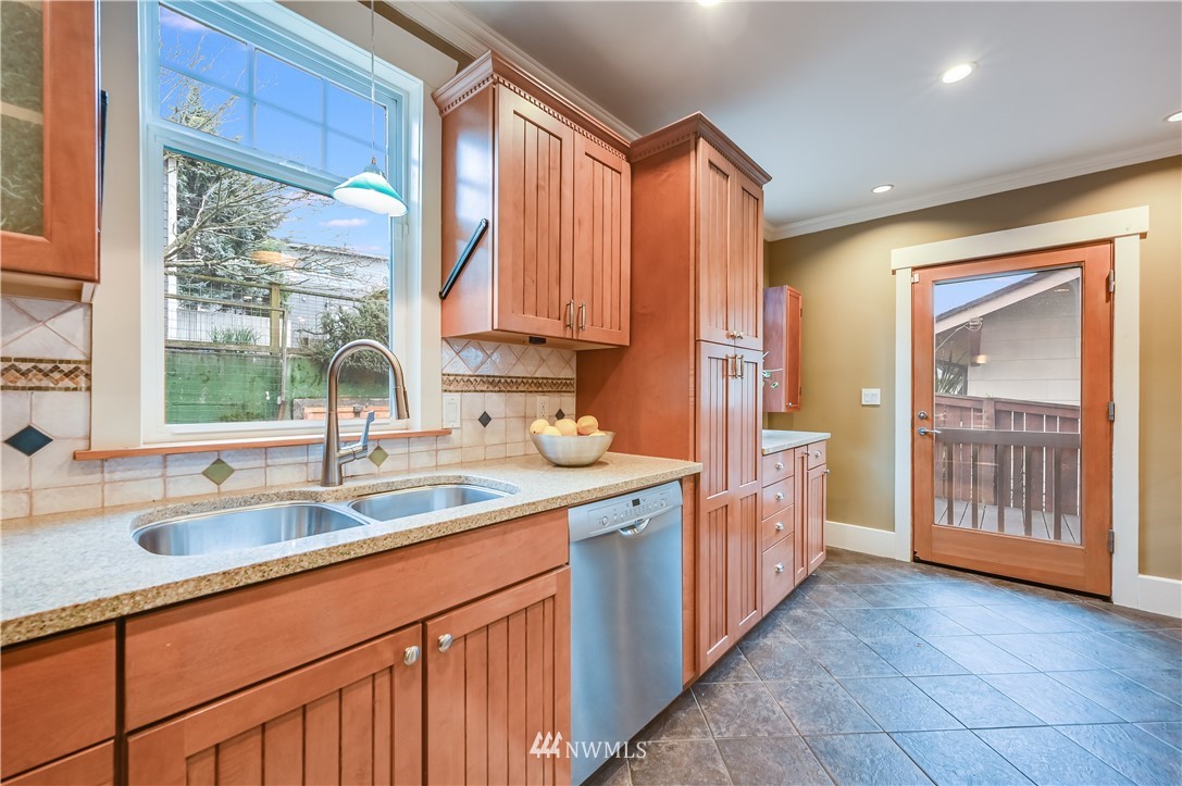 6016 44th Avenue Southwest Seattle, WA 98136 - Photo 11 of 35 a kitchen with stainless steel appliances granite countertop a sink and a wooden cabinets