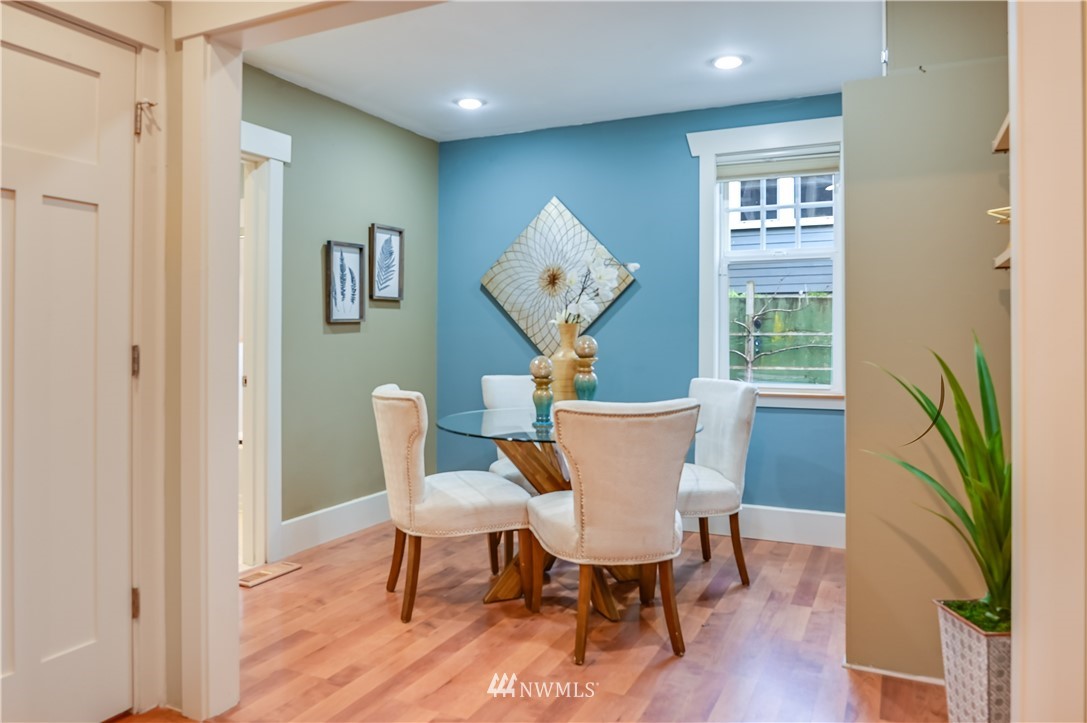 6016 44th Avenue Southwest Seattle, WA 98136 - Photo 13 of 35 a view of a dining room with furniture wooden floor and a chandelier