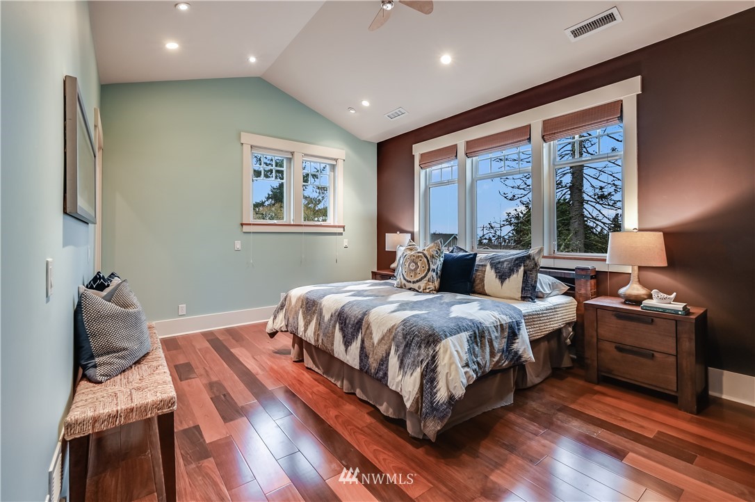 6016 44th Avenue Southwest Seattle, WA 98136 - Photo 19 of 35 a bedroom with a bed and wooden floor