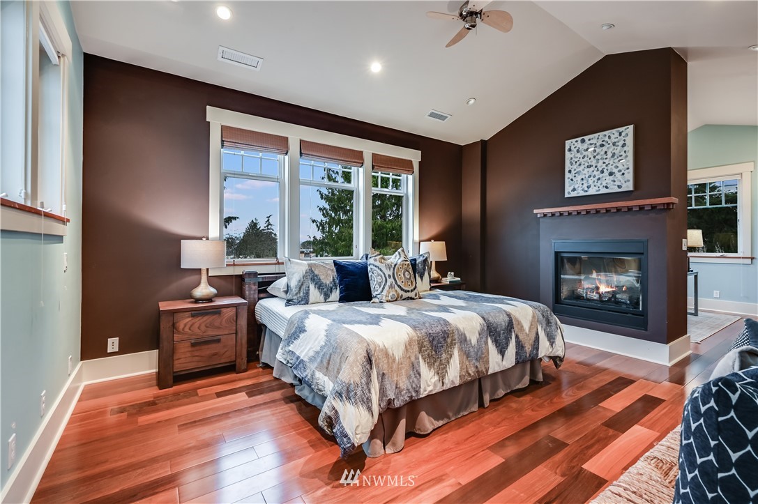6016 44th Avenue Southwest Seattle, WA 98136 - Photo 20 of 35 a bed room with a bed and a fireplace