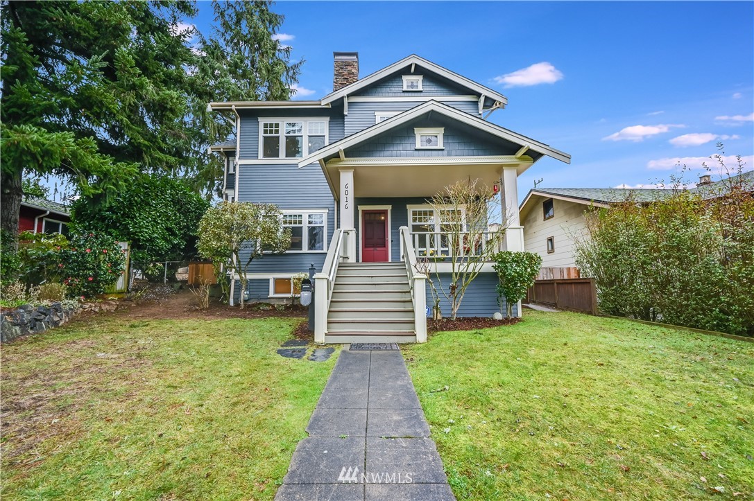 6016 44th Avenue Southwest Seattle, WA 98136 - Photo 2 of 35 a front view of a house with a yard