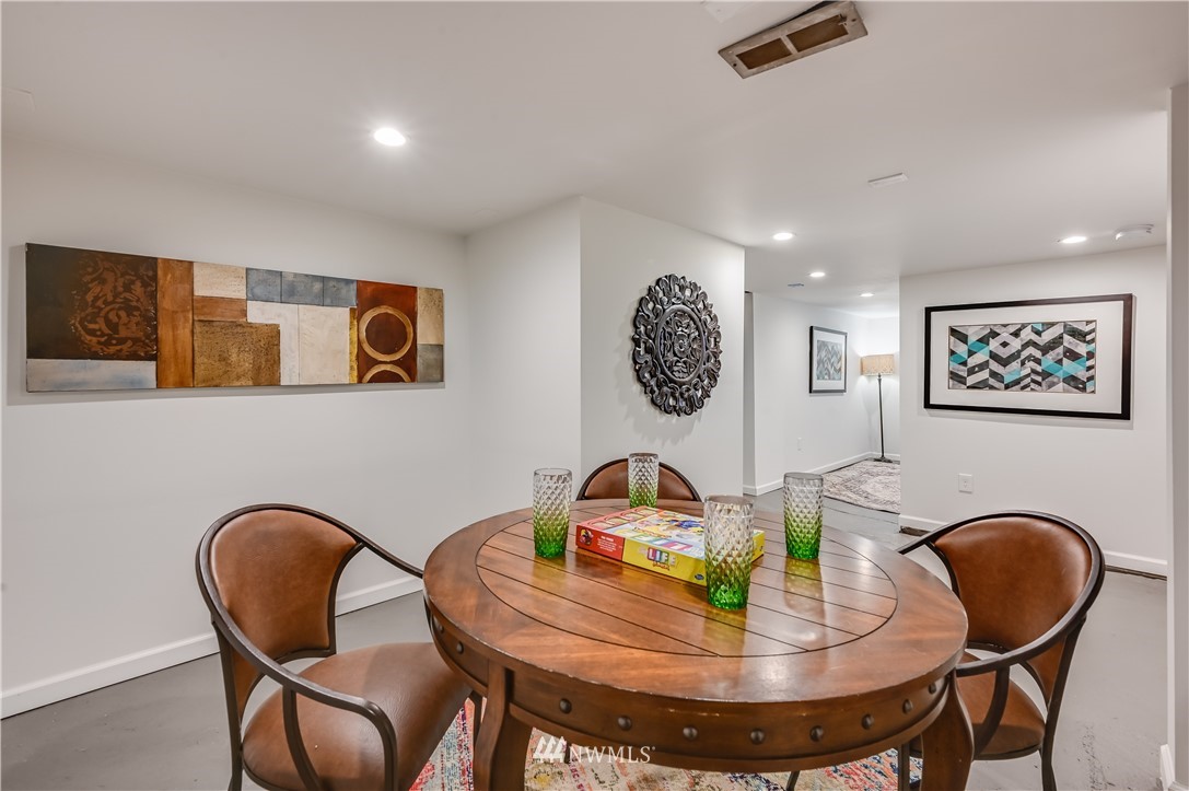 6016 44th Avenue Southwest Seattle, WA 98136 - Photo 27 of 35 a dining room with furniture and wooden floor